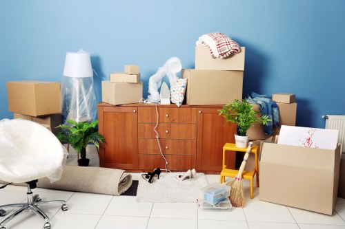 House removal team handling boxes and furniture in a Westwimbledon property