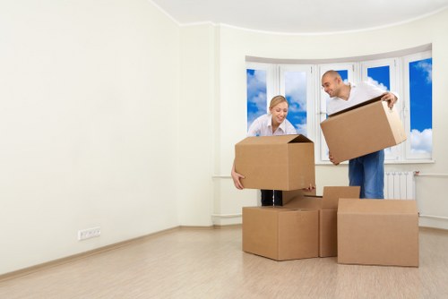 Local movers handling furniture and boxes on a residential street