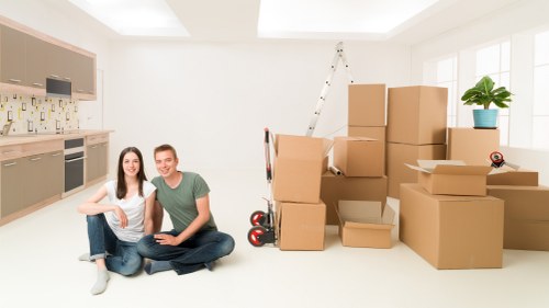 Movers loading household items carefully for transport in Westwimbledon