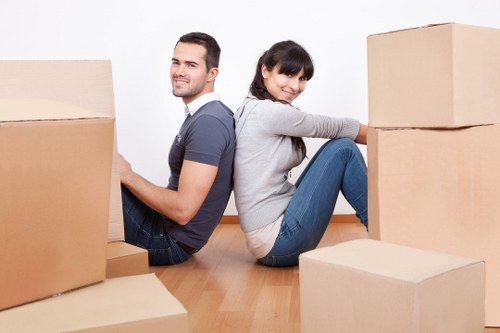 Movers loading furniture into a removal vehicle