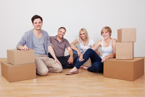 Movers handling desks and workstations in a local office move